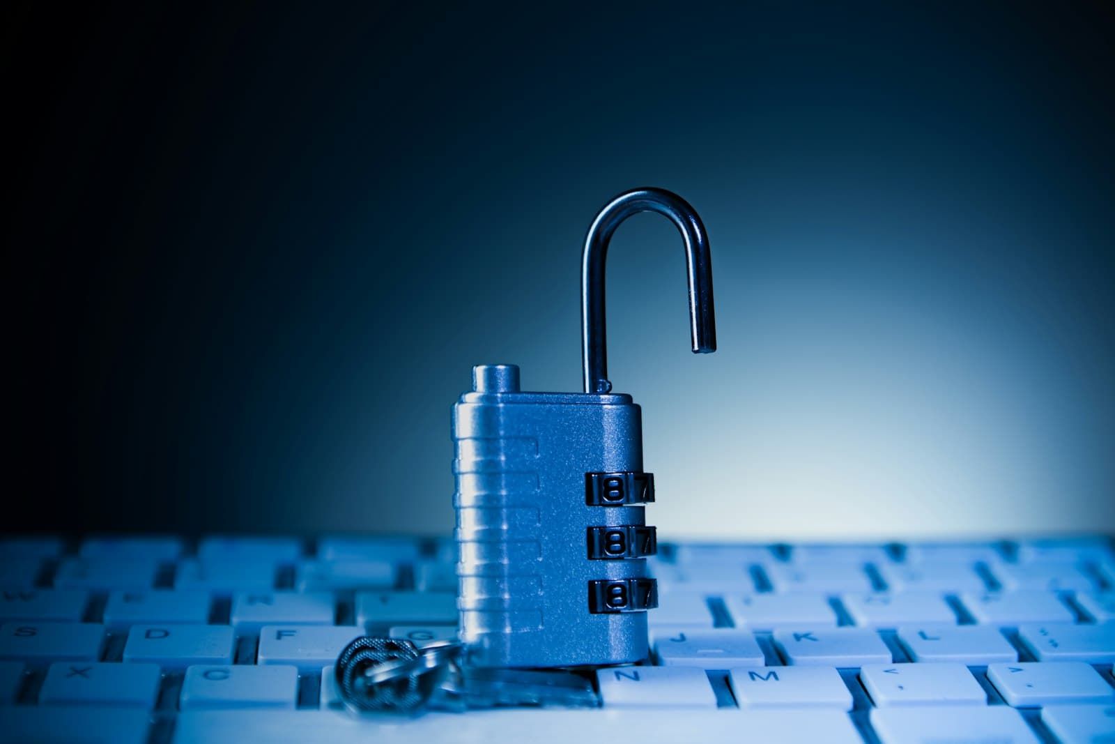 An unlocked padlock on a computer keyboard